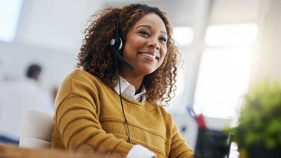 Happy support agent woman with headphones