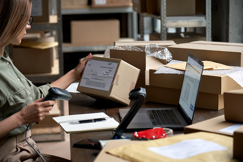 Business owner shipping orders after ecommerce transactions