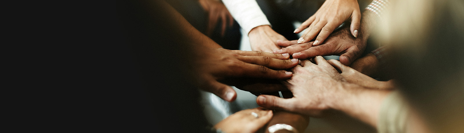 Group of people with hands in the middle